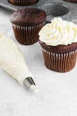 Chocolate cupcake decorated with cream