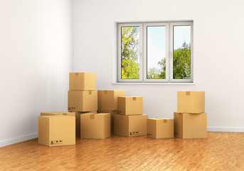 Empty room with a window and white walls with moving cardboard b