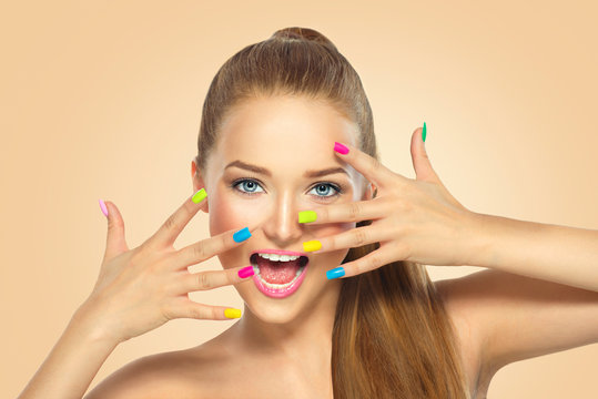 Fototapeta Beauty girl with colorful nail polish. Manicure and makeup