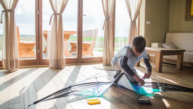 Preparing wind kite in living room floor