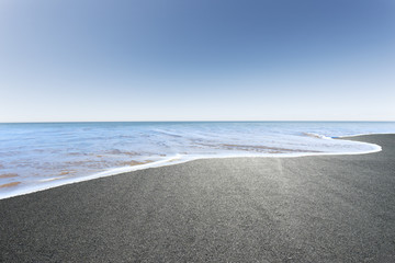 asphalt road covered by seawater in summer day in new zealand