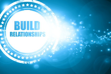 Blue stamp on a glittering background: build relationships
