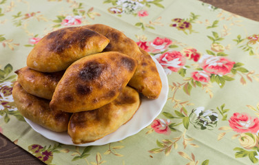 Russian patties with cabbage on a dish  on the colorful cloth
