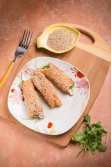salmon rolled up with sesame seeds ricotta and arugula