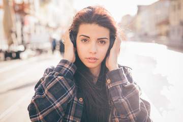 Young beautiful redhead brown hair mixed race woman listening to