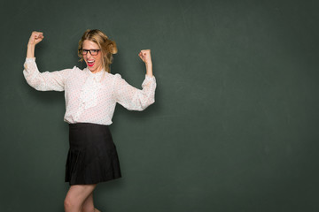 Nerd dork fashion flexes arms and celebrates strength power confident ego inner pride independence individuality unique 