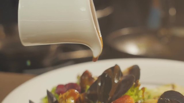 Dressing the salad with seafood and lettuce with sauce