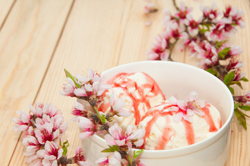 Fototapeta na wymiar Vanilla ice cream with cherry on wooden background