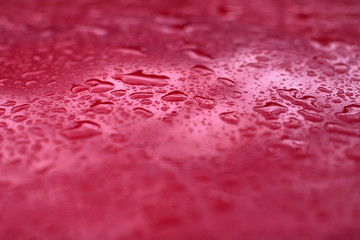 Rain drops on red background