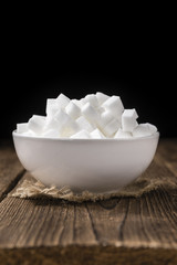 White Sugar (selective focus) on wooden background