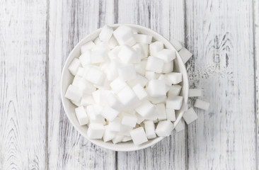 White Sugar (selective focus) on wooden background