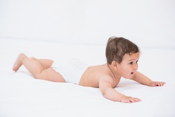 Cute baby relaxing on bed 