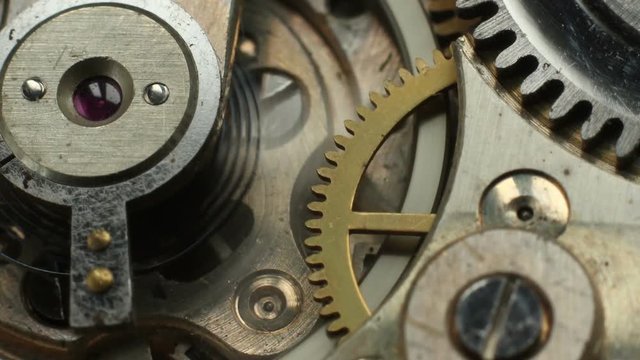 Old mechanical watch mechanism macro time lapse.