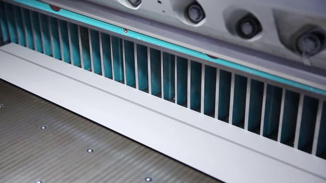 Cutting paper shears cutter guillotine machine in a printing factory
