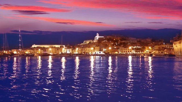 Ibiza Eivissa town sunset with city lights reflection in Mediterranean sea of balearic Islands of Spain