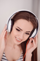 Cheerful pleasant girl listening to music 