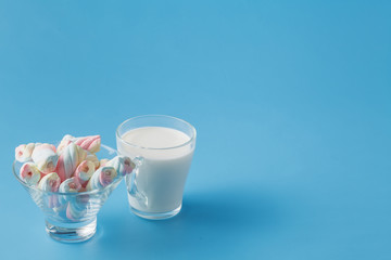 Milk amd flowers on blue background