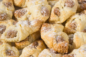 Homemade hot nutty buns sprinkled sweet white sugar on the white