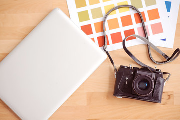Laptop standing near photo camera - Powered by Adobe