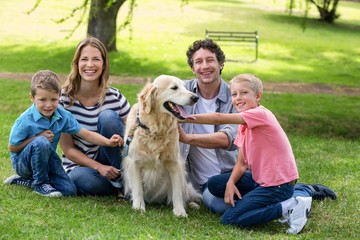 Fototapeta premium Family with dog in the park