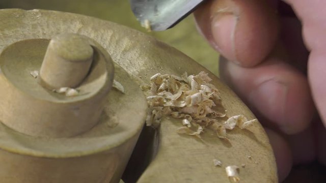 Luthier sculpt a cello head