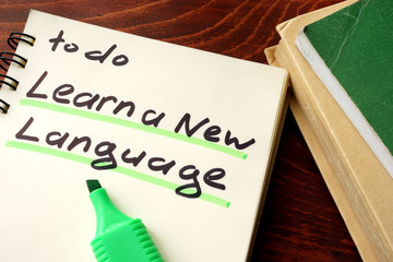 Learn a new language written on a notepad. Education concept.