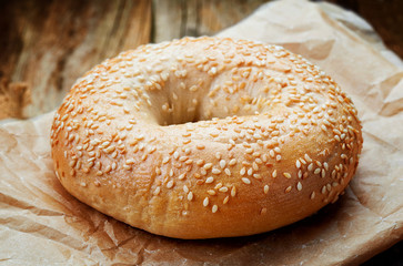 Sesame bagel on wooden table
