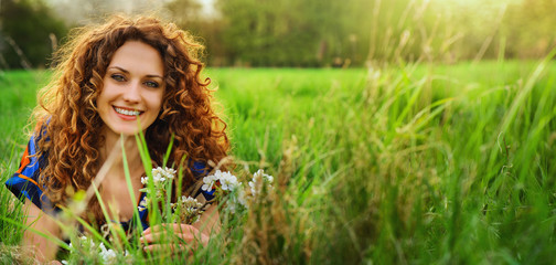 beautiful girl lying down of grass