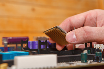 repairman inserted CPU into the socket on the motherboard. Close