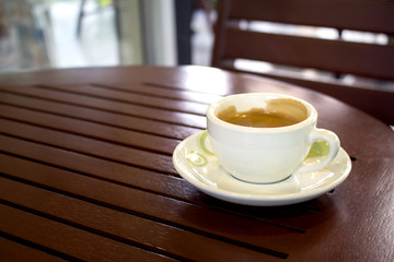 close-up, Cup of Coffee on table in coffee shop [blur and select focus background]