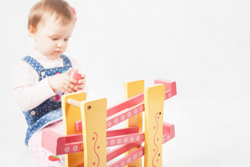 Funny baby girl playing with toy game for development