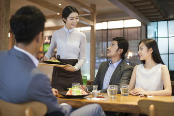 Waitress serving in restaurant