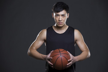 Young man holding a basketball