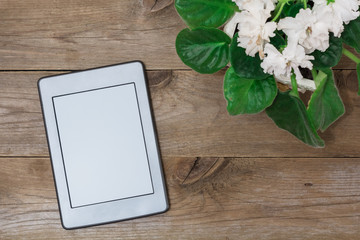 Grey electronic book and flower