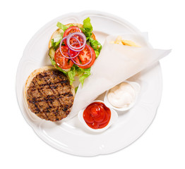 Delicious beef burger with potato fries.