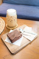 Delicious ice coffee and  Chocolate Brownie on wooden tray