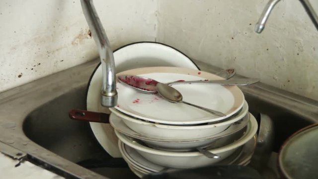 Dirty Dishes in the Sink of the Old Home Kitchen