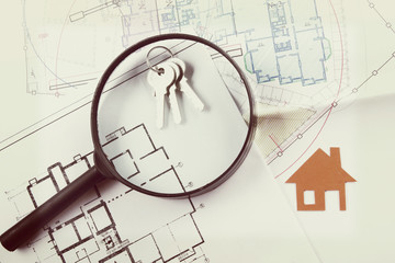 Model house, construction plan for house building, keys. Real Estate Concept. 