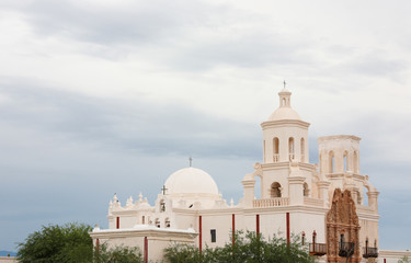 Fototapeta na wymiar Mission San Xavier del Bac on a Cloudy Day. Mission San Xavier del Bac is a historic Spanish Catholic mission located at Tucson, Arizona.