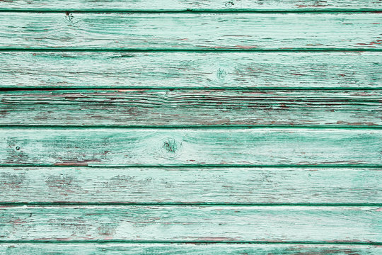Green peeling paint wooden background.