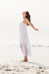 Fototapeta na wymiar Beautiful woman stretching on the beach