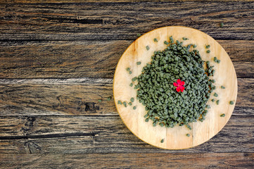 Ginseng Green Oolong Tea on wooden board on wooden background