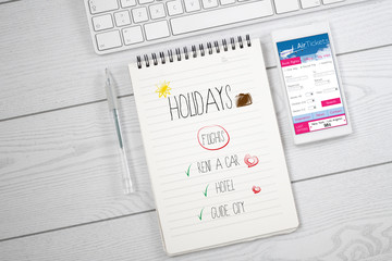 white desktop with air tickets web and holidays planning