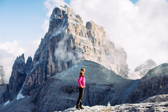Girl tourist admires the peaks in the Alps