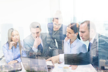 business team with laptop having discussion