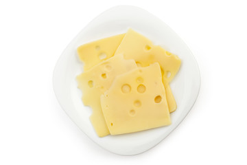 Slice of fresh emmental cheese on white plate and white background, cow cheese