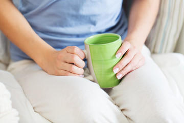 close up of young woman with tea cup