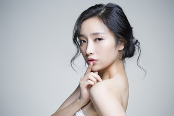 Young woman posing against white background