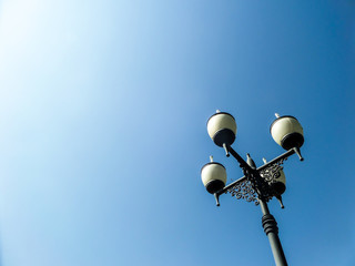 Four lamps street light blue sky background