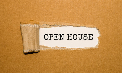 The text Open House appearing behind torn brown paper
